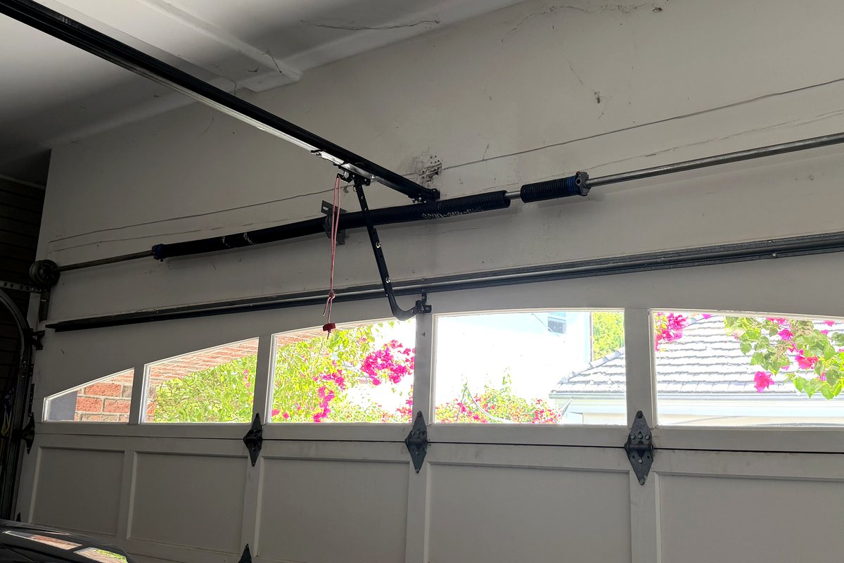Torsion springs mounted on the shaft above a residential garage door